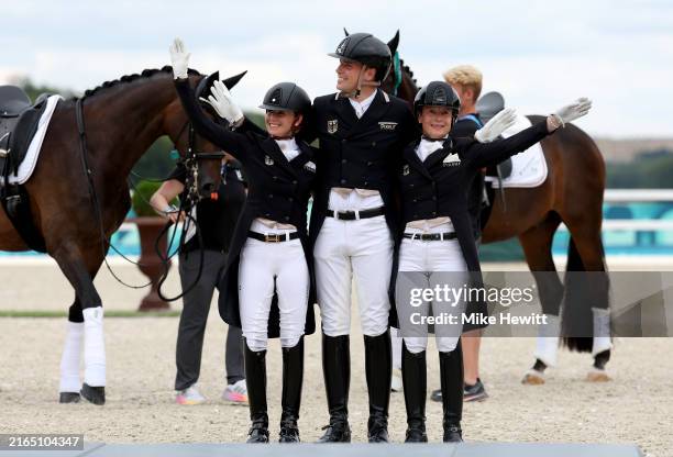 Gold medalists Jessica Von Bredow-Werndl, Frederic Wanders and Isabell Werth of Team Germany celebrate during the medal ceremony for the Dressage...