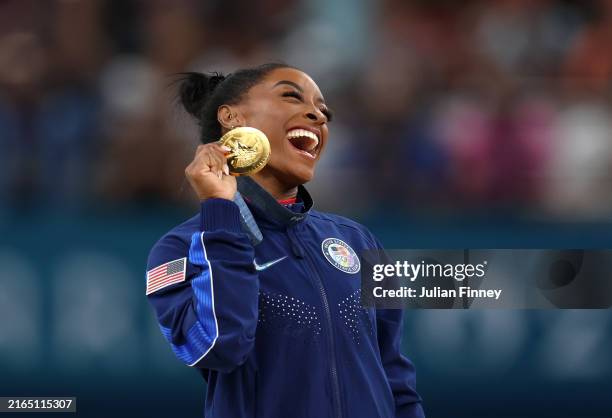 Gold medalist Simone Biles of Team United States celebrates on the podium during the medal ceremony for the Artistic Gymnastics Women's Vault Final...
