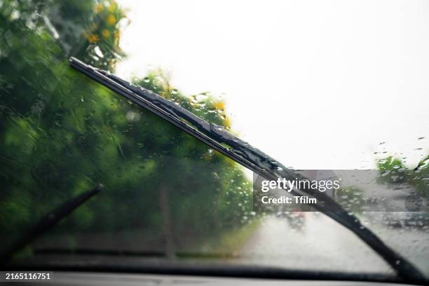 windshield wipers clearing rain on a drive - misty eyes stock pictures, royalty-free photos & images