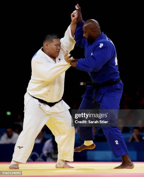 Tatsuru Saito of Team Japan and Teddy Riner of Team France compete in the Men +90kg during the Judo Mixed Team Final on day eight of the Olympic...