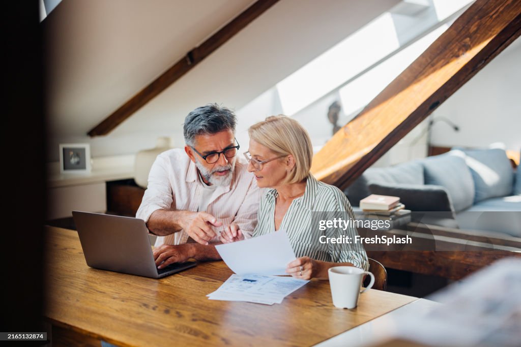 Senior Couple Working on Documents at Home Office Desk