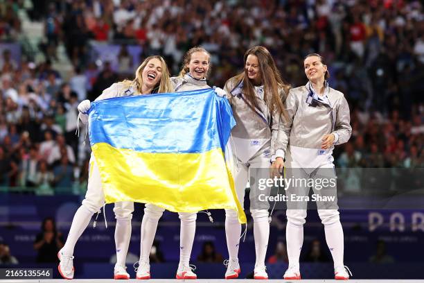 Olga Kharlan, Yuliia Bakastova, Olena Kravatska and Alina Komashchuk of Team Ukraine celebrate following their during the Fencing Women's Sabre Team...