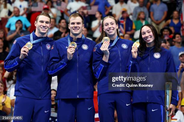 Gold Medalists Ryan Murphy, Nic Fink, Gretchen Walsh and Torri Huske of Team United States pose on the podium during the Swimming medal ceremony...