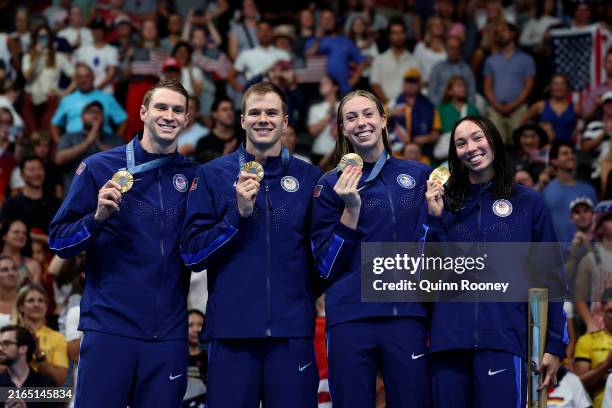 Gold Medalists Ryan Murphy, Nic Fink, Gretchen Walsh and Torri Huske of Team United States pose on the podium during the Swimming medal ceremony...