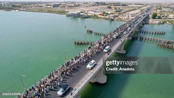 An aerial view of thousands of Shia Muslims marching towards the Karbala city as part of the events marking the martyrdom of Imam al-Hussein, the...