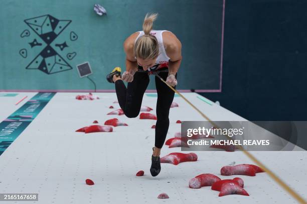 An overview shows Poland's Aleksandra Miroslaw celebrates after winning the women's sport climbing speed final during the Paris 2024 Olympic Games at...