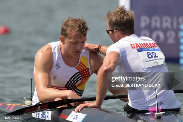 Denmark's Rene Holten Poulsen conforts Belgium's Artuur Peters after the men's kayak single 1000m quarterfinals canoe sprint competition at...
