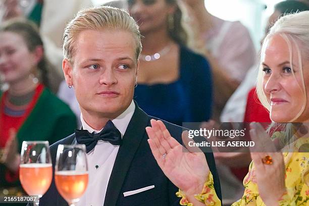 Picture taken on June 16, 2022 in Oslo, Norway, shows Marius Borg Høiby sitting next to his mother Norwegian Crown Princess Mette-Marit. The...