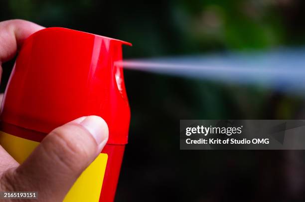 hand spraying aerosol can, insect repellent - bug spray stock pictures, royalty-free photos & images