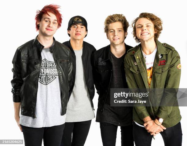 Michael Clifford, Calum Hood, Ashton Irwin and Luke Hemmings of 5 Seconds of Summer pose for a portrait backstage at the KIIS FM Jingle Ball on...