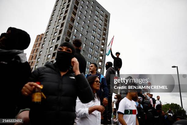 People gather for a counter demonstration against an anti-immigration protest called by far-right activists in the Walthamstow suburb of London on...