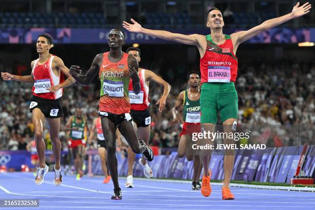 Morocco's Soufiane El Bakkali celebrates after winning the men's 3000m steeplechase final of the athletics event at the Paris 2024 Olympic Games at...