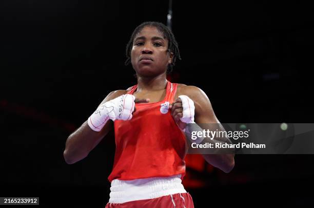 Cindy Winner Djankeu Ngamba of Refugee Olympic Team poses for a photo after winning the Women's 75kg Quarter-final match against Davina Michel of...