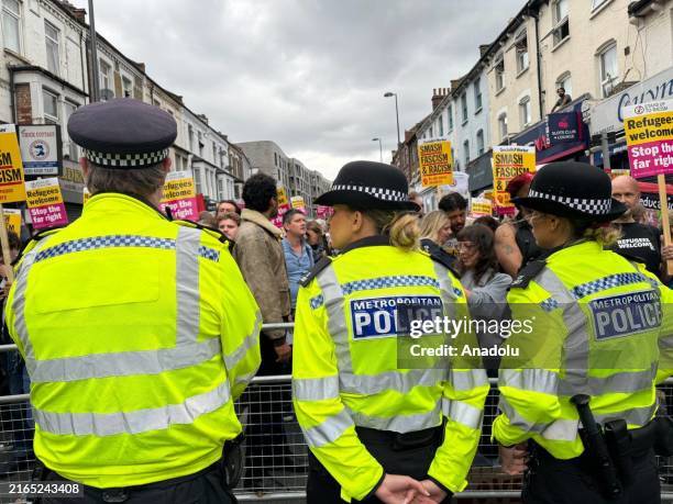 Police officers take security measures during a demonstration against anti-immigration protests in Walthamstow, London, United Kingdom on August 07,...