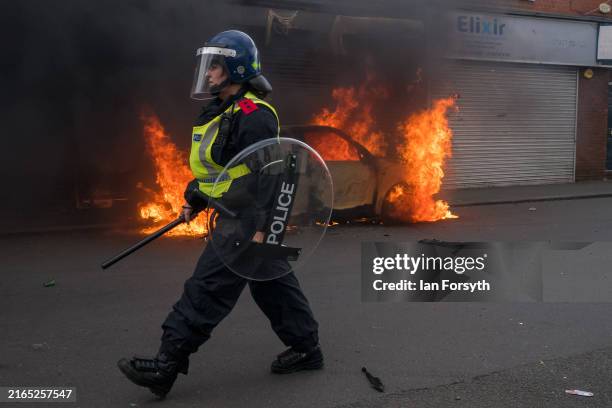 Car burns on Parliament Road after it was set alight by far-right activists holding a demonstration in Middlesbrough on August 04, 2024 in...