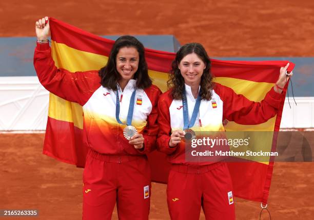 Bronze Medallists, Sara Sorribes Tormo and Cristina Bucsa of Team Spain pose with the Spanish flag on the podium during the Tennis Women's Doubles...