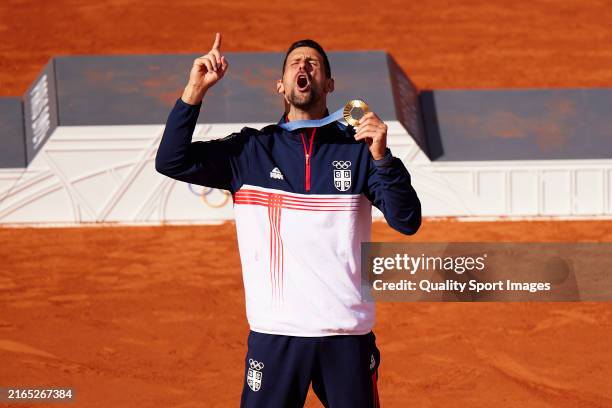 Gold medalist Novak Djokovic of Team Serbia celebrates on the podium during the Tennis Men's Singles medal ceremony after the Tennis Men's Singles...
