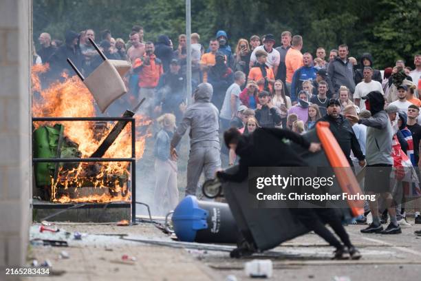 Anti-migration protesters attempt to enter the Holiday Inn Express Hotel which is housing asylum seekers on August 4, 2024 in Rotherham, United...