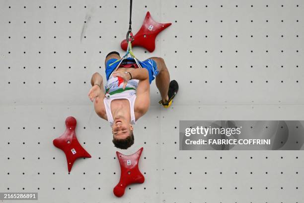 Italy's Matteo Zurloni reacts after losing a men's sport climbing speed quarter-final during the Paris 2024 Olympic Games at Le Bourget Sport...