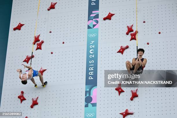China's Wu Peng reacts after he wins ahead of Italy's Matteo Zurloni in a men's sport climbing speed quarter-final during the Paris 2024 Olympic...