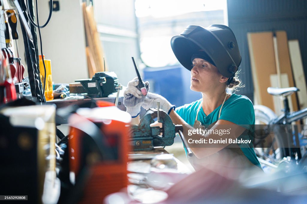 Art From Scrap. Female Artist Makes Recycled Metal Art by TIG Welding.