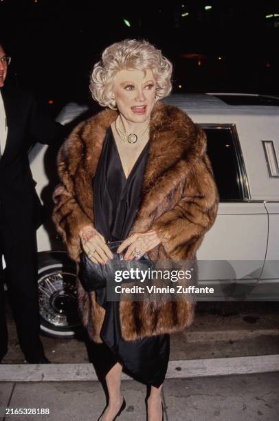 American comedian and actress Phyllis Diller wearing a brown fur coat arriving for the stage production of 'Private Lives' at the Wilshire Theater in...