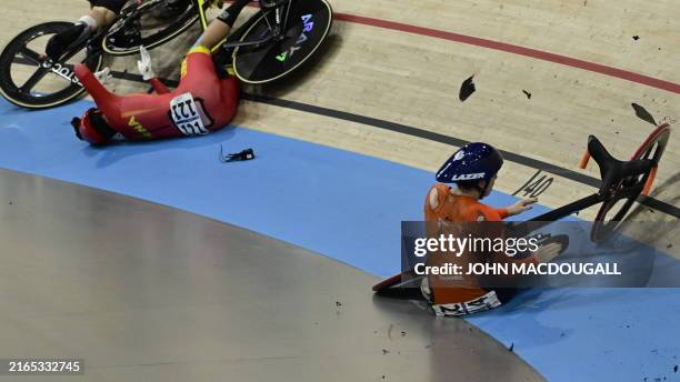 Belgium's Nicky Degrendele and China's Yuan Liying crash in a women's track cycling keirin quarter-final of the Paris 2024 Olympic Games at the...