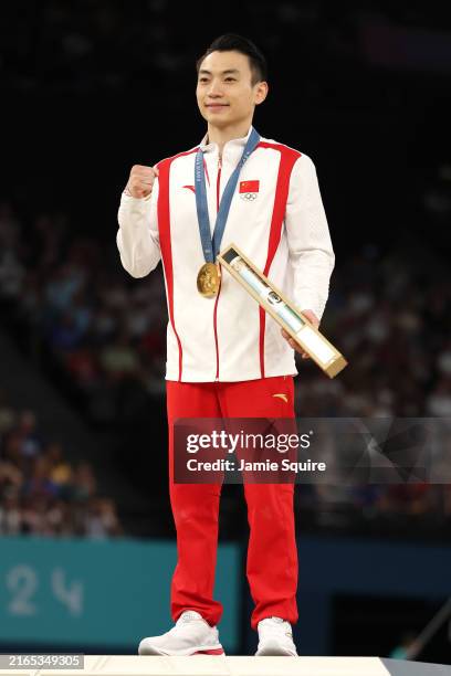 Gold medalist Zou Jingyuan of Team People's Republic of China celebrates on the podium during the medal ceremony for the Artistic Gymnastics Men's...