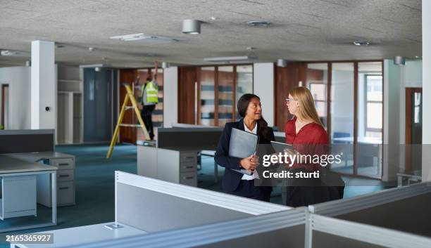 estate agent showing prospective tenant the office space - lease agreement stock pictures, royalty-free photos & images