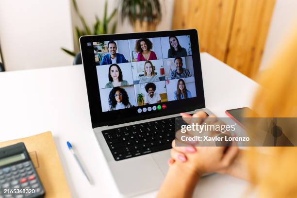 laptop screen view over female shoulder during group video call with diverse people. - zoom class stock pictures, royalty-free photos & images