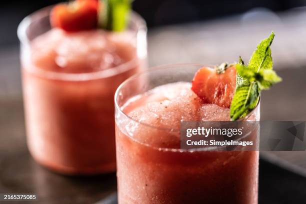 refreshing strawberry daiquiri drink on bar counter in night club. - daiquiri stock pictures, royalty-free photos & images