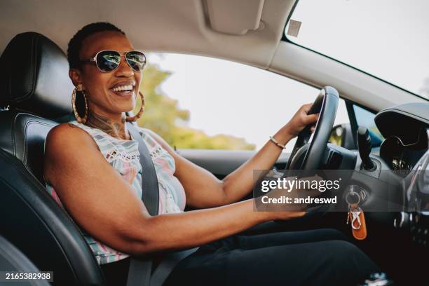 portrait of a woman driving a car - driving stock pictures, royalty-free photos & images