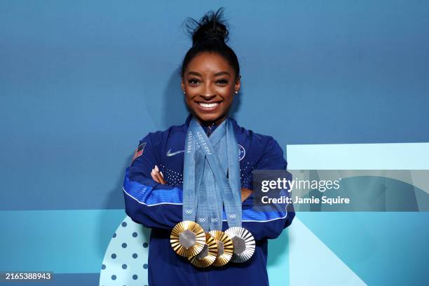 Simone Biles of Team United States poses with her Paris 2024 Olympic medals following the Artistic Gymnastics Women's Floor Exercise Final on day ten...