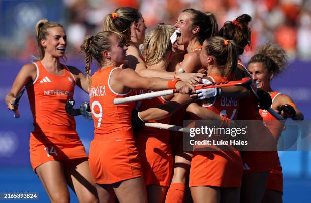 Xan de Waard of Team Netherlands celebrates scoring her team's first goal with teammates during the Quarter Final Women's match between Netherlands...