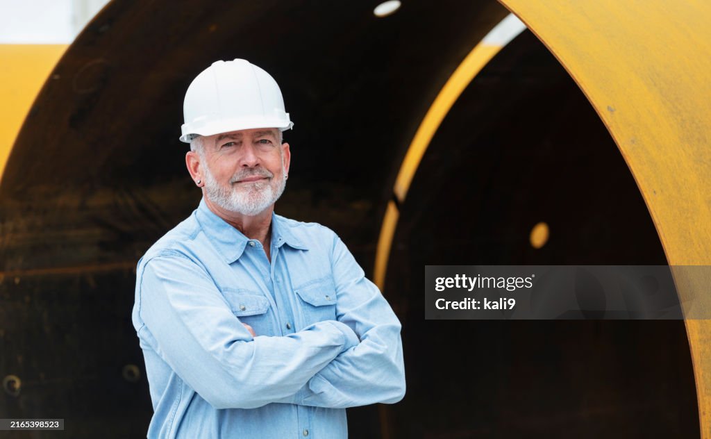 Senior man working at steel fabrication factory