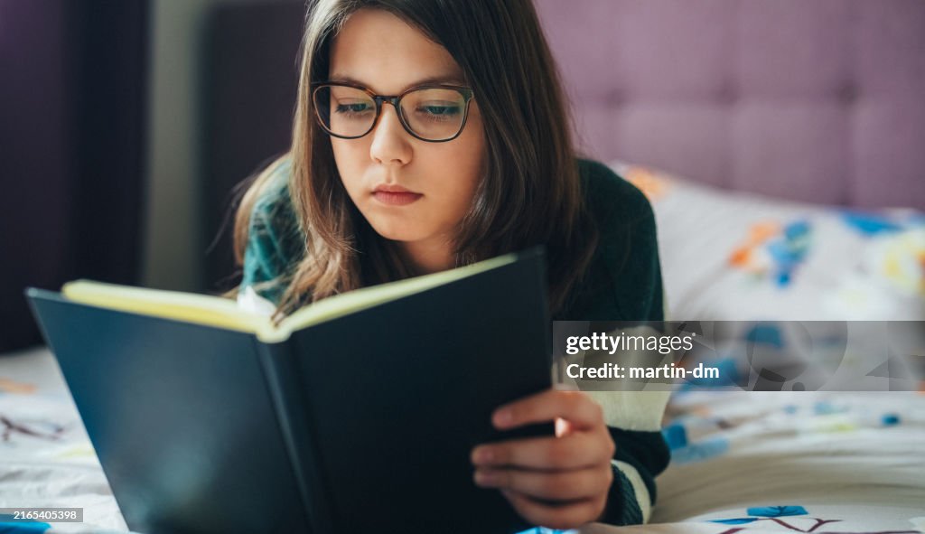 Girl reading a book at home