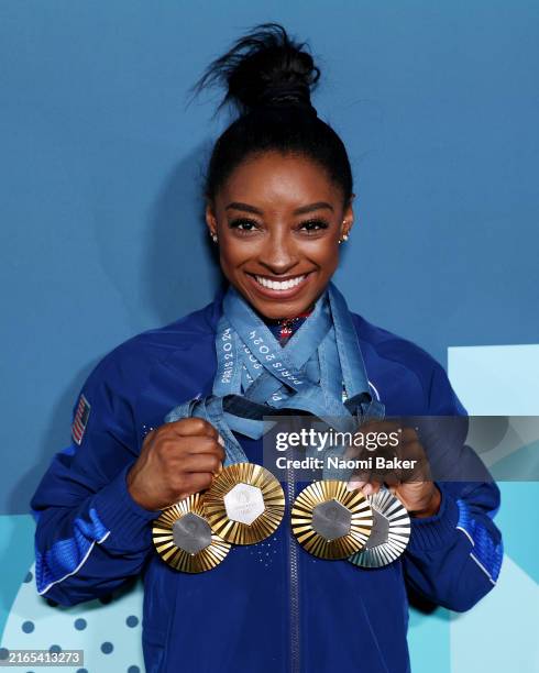 Simone Biles of Team United States poses with her Paris 2024 Olympic medals following the Artistic Gymnastics Women's Floor Exercise Final on day ten...