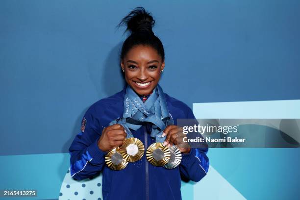 Simone Biles of Team United States poses with her Paris 2024 Olympic medals following the Artistic Gymnastics Women's Floor Exercise Final on day ten...