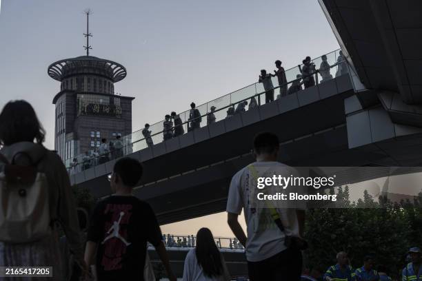 Pedestrians in Pudong's Lujiazui Financial District in Shanghai, China, on Wednesday, Aug. 7, 2024. The People's Bank of China is potentially getting...