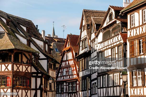historic half-timbered houses in petite france historic district on a sunny day, strasbourg, france - historia social fotografías e imágenes de stock