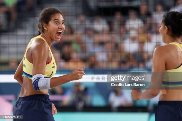 Ana Patricia Silva Ramos and Eduarda Santos Lisboa of Team Brazil react during a Women's Round of 16 match against Team Japan on day ten of the...