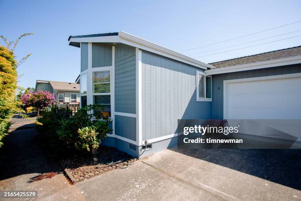 exterior of small blue gray mobile home with a front porch - home exterior wood siding stock pictures, royalty-free photos & images