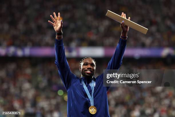 Gold medalist Noah Lyles of Team United States celebrates on the podium during the Men's 100m medal ceremony on day ten of the Olympic Games Paris...