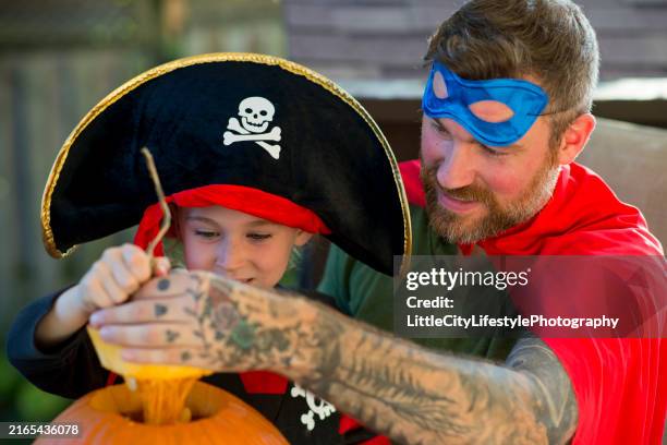 making a jack-o-lantern with dad - pirate hats for kids stock pictures, royalty-free photos & images