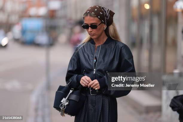 Emili Sindlev is seen wearing a brown bandana in her hair; black rectangular sunglasses from Miu Miu; several golden hoop earrings; a matching...