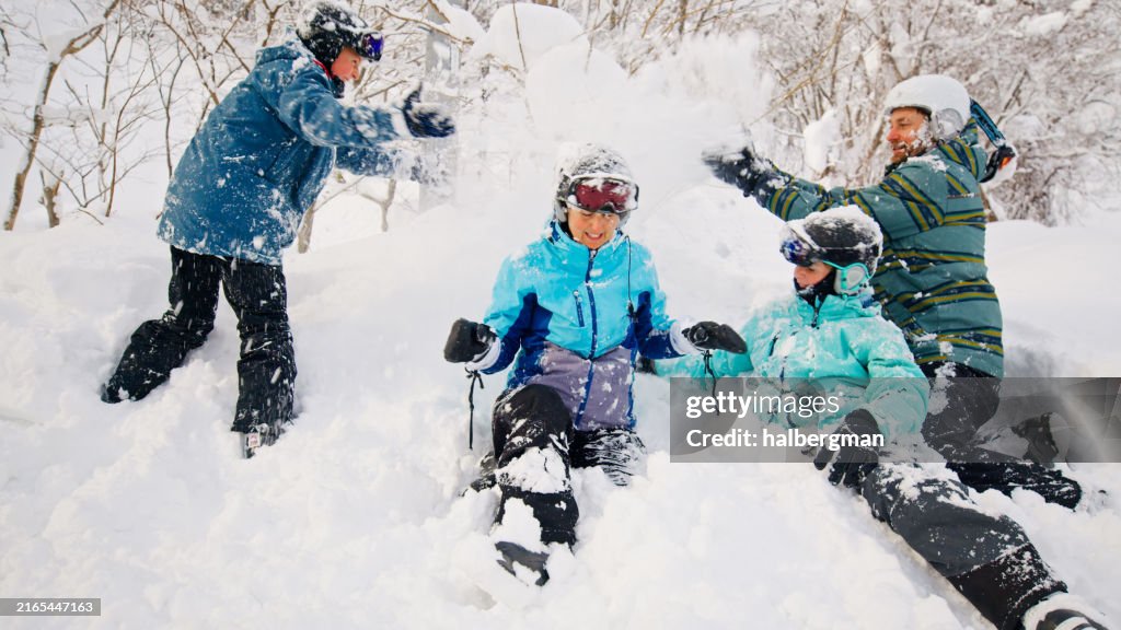 Two Parents Playing in the Snow with their Children