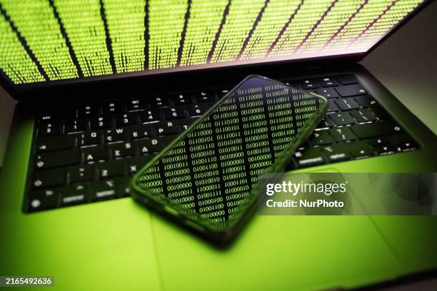 Binary code is being displayed on a smartphone and on a computer screen in Chania, Greece, on August 9, 2024.