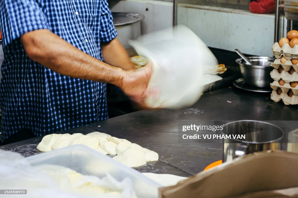 Making the roti prata in Little India, Singapore