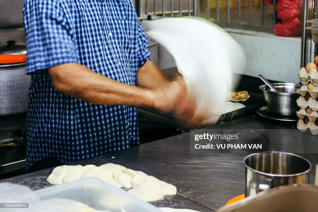 Making the roti prata in Little India, Singapore