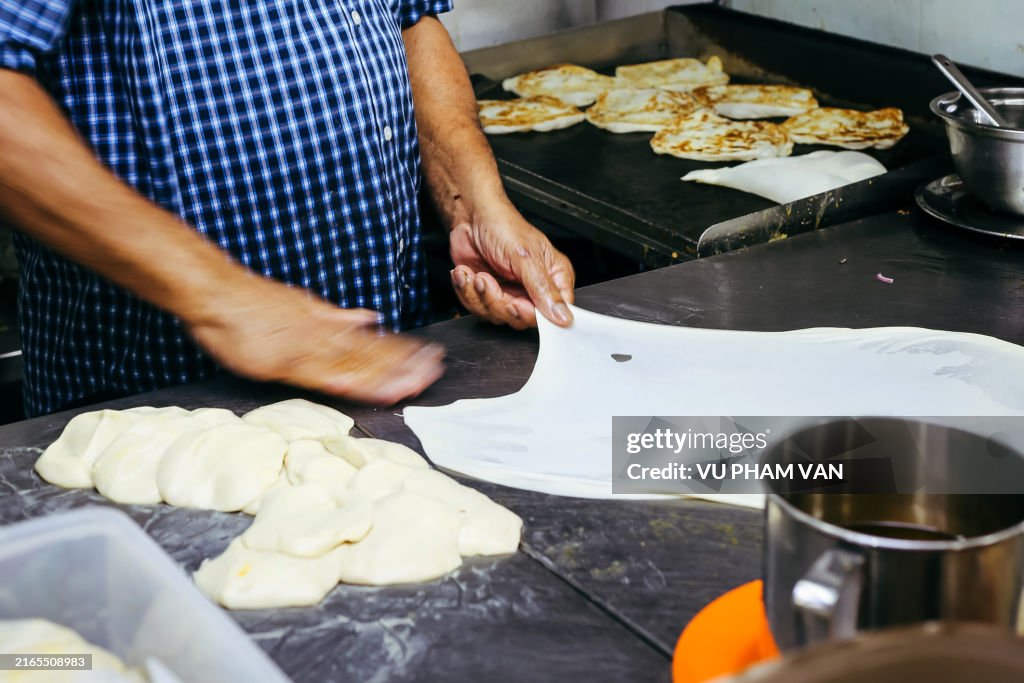Making the roti prata in Little India, Singapore